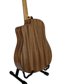 The back of an acoustic guitar with a rich wood grain finish, displayed on a black stand against a clean white background.