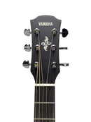 Close-up of a Yamaha acoustic guitar headstock with six tuning pegs, gold strings, and a white Yamaha logo on a light gray background.