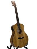 A natural wood acoustic-electric guitar with a black pickup and black stand, photographed against a neutral light gray background.