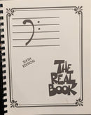 Music book titled 'The Real Book'